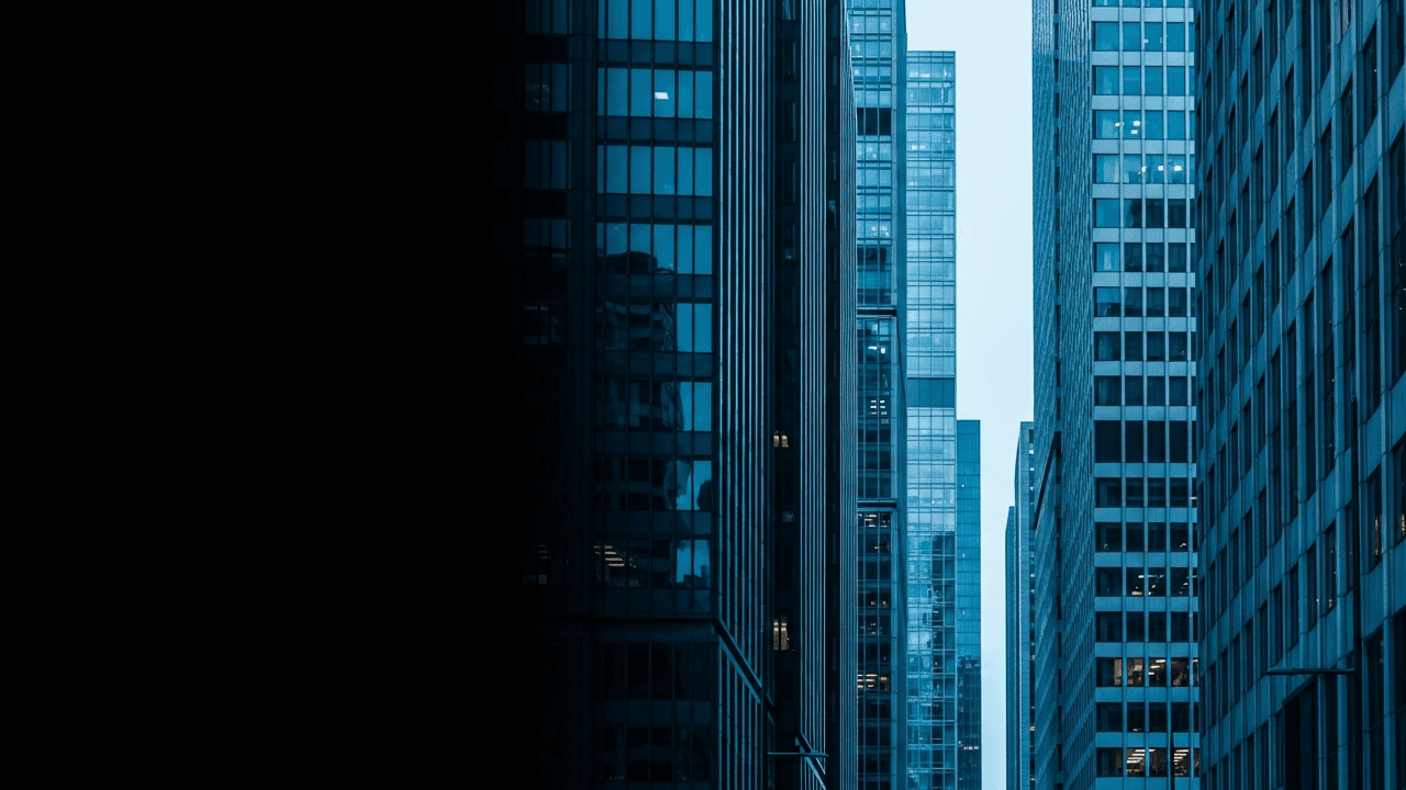 Text-free blue-hour glass towers in an international financial district
