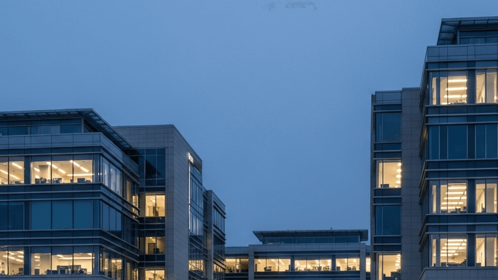 Anonymous corporate office buildings at blue hour