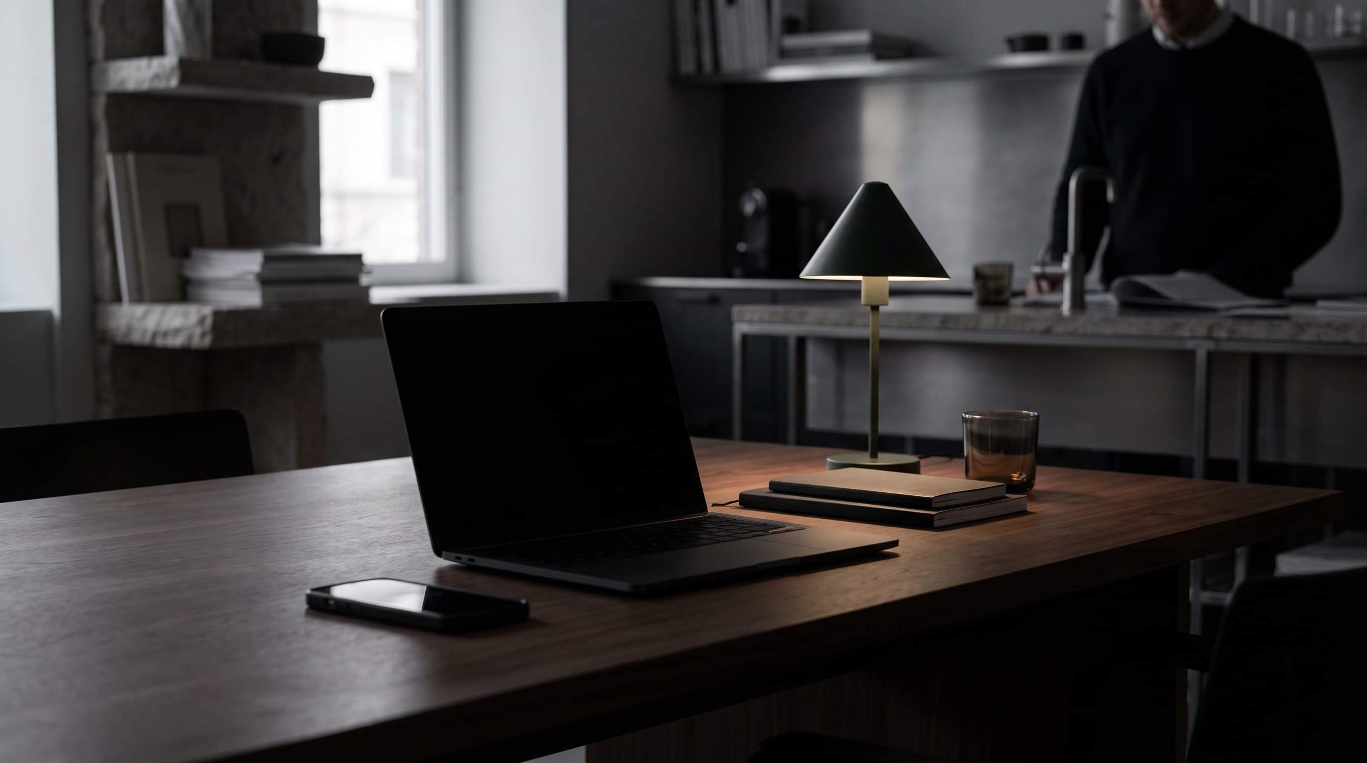 Closed laptop and phone on a quiet desk